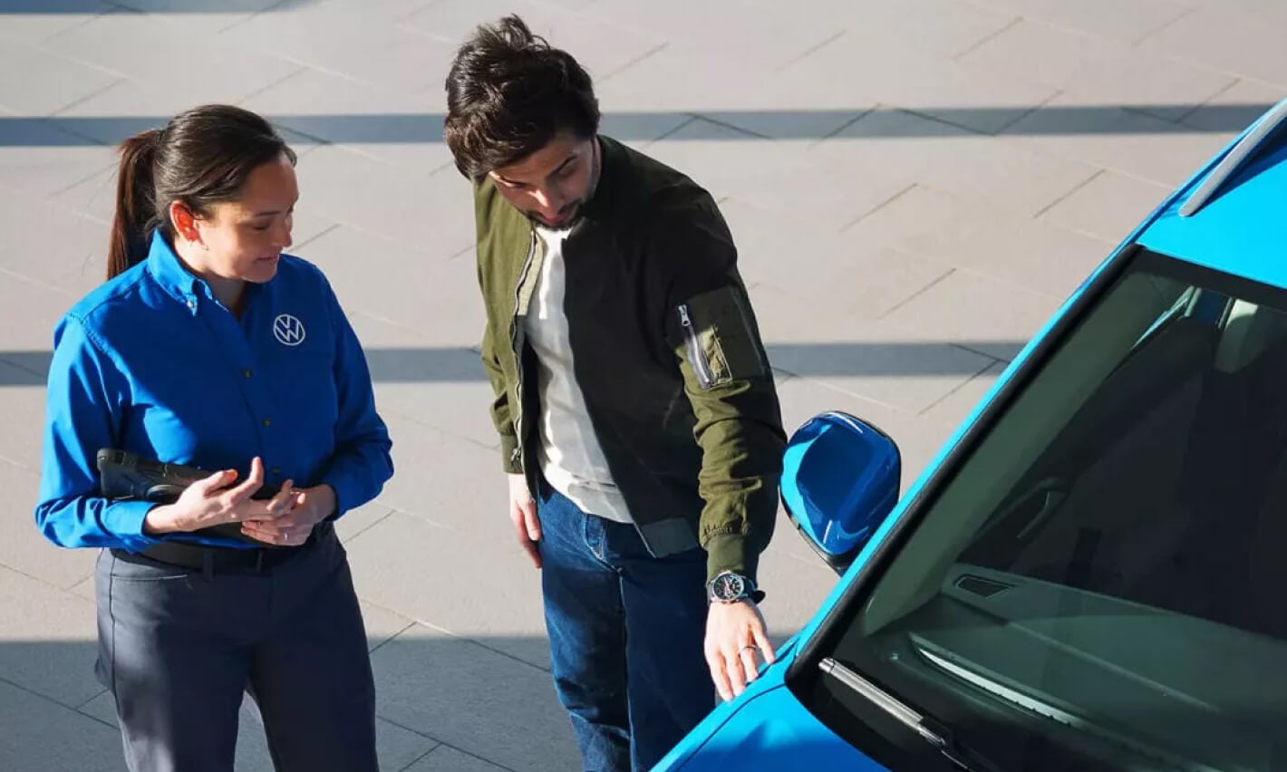 Volkswagen dealership associate assiting customer